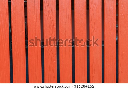 vertical orange wooden fence close up