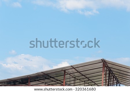 Architectural detail of metal roofing on commercial construction of modern building complex,which has Sky and clouds