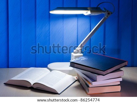 open book and pile books is on desk