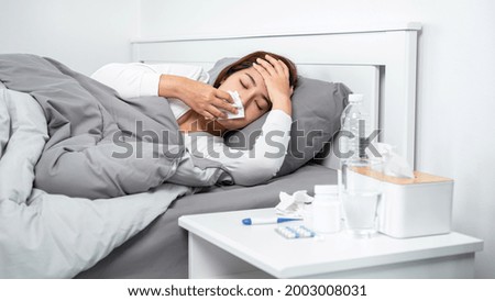 Similar – Image, Stock Photo Sick woman checking body temperature near window at home