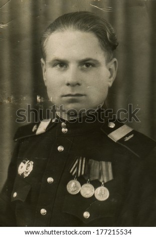 AUSTRIA - CIRCA 1945: An antique photo shows studio portrait of a Red Army staff sergeant, tank mechanic.
