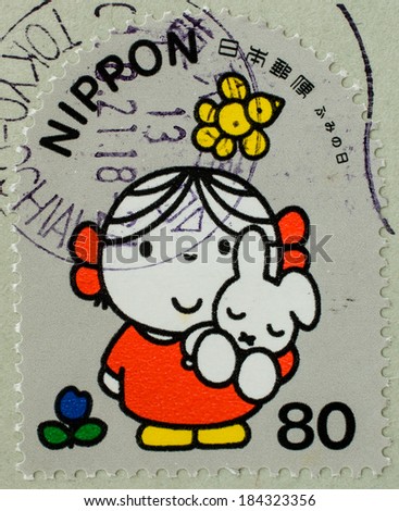 JAPAN - CIRCA 2001: A stamp printed in Japan, shows a picture of girl and rabbit, circa 2001