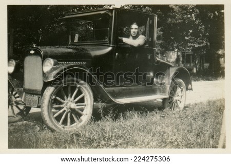 USA- CIRCA 1920s: Vintage photo shows the man behind the wheel of a car.
