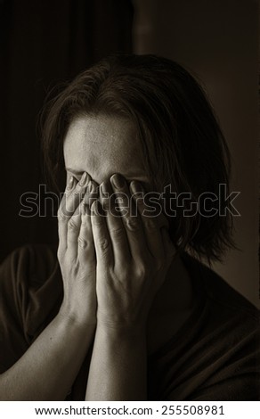 Frustrated woman. Hands covered his face