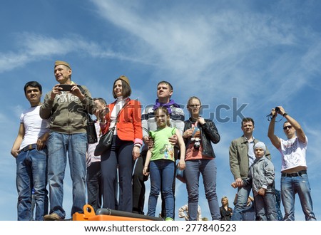 MOSCOW - MAY 9, 2014: Victory day celebrations in Moscow. People watch the parade of military hardware
