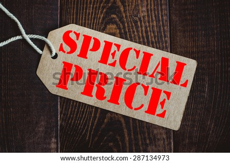 Special price. Blank tag on dark wood background