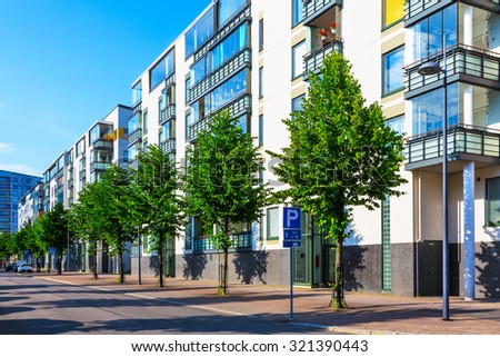 Creative abstract house building and city construction industry concept: summer outdoor urban view of urban city street with modern real estate homes