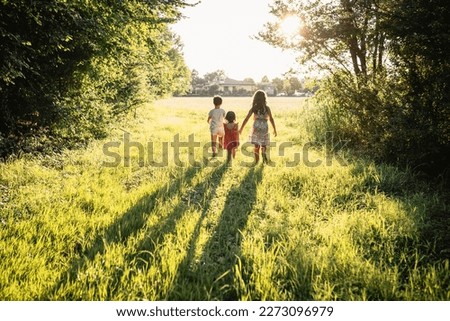 Similar – Image, Stock Photo Three children with three wheels sitting on the ground in front of a house in South America