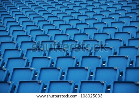 blue folding plastic seats at an outdoor event