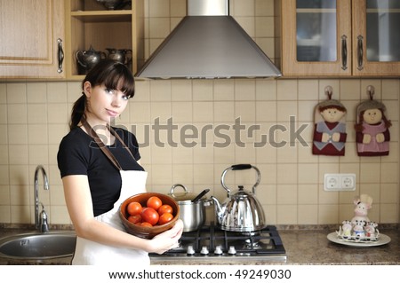 Young housewife in kitchen
