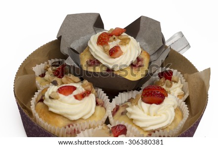 Group of homemade strawberry cupcakes in a gift box with ribbon