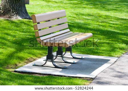An empty park bench waiting for someone to sit.