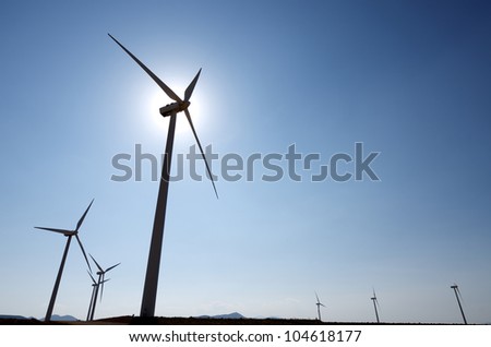 silhouette of a group of windmills for renewable electric energy production