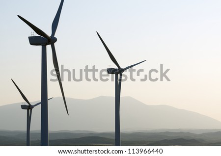 silhouette of a group of windmills for renewable electric energy 
