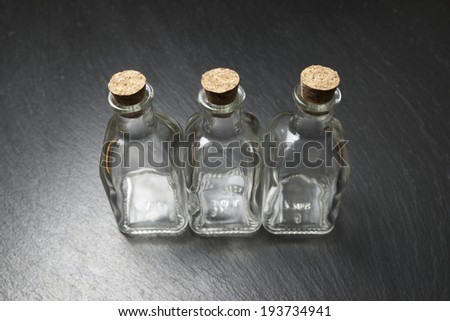 small empty bottles on a black slate
