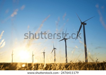 Similar – Image, Stock Photo Wind energy. Wind power. Sustainable, renewable energy. Wind turbines generate electricity. Windmill farm on mountain with sunset sky. Green technology. Renewable resource. Sustainable development.