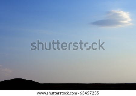 flat horizon at sunset and white cloud