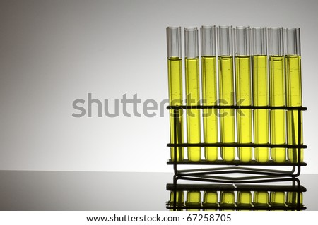 group of test tubes with yellow fluid
