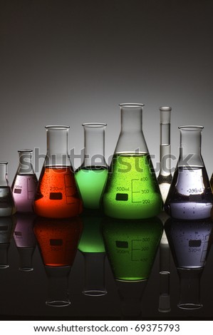 group of laboratory flasks containing liquid color