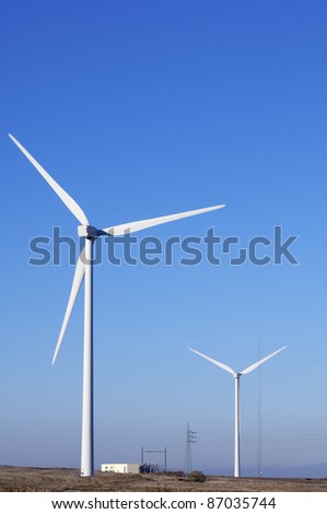 two windmills for electric power generation alternative and electrical substation