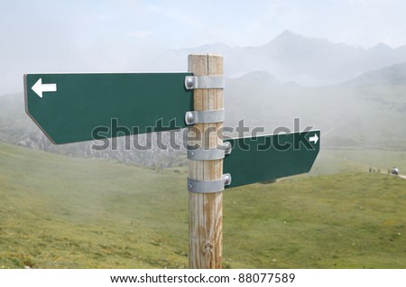 view of two wooden directional signs on a pole