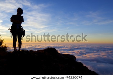 silhouette of a climber with  sunset and sea of ??clouds, Cap of Ras, Ager,  Lleida, Catalonia, Spain