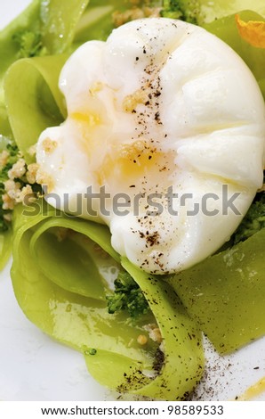 Poached egg with mushroom powder, icing and vegetables