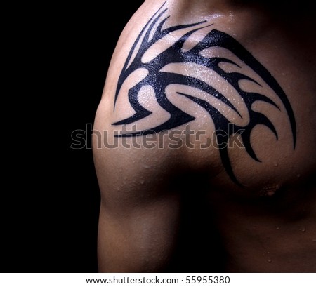 Tribal tattoo on male shoulder