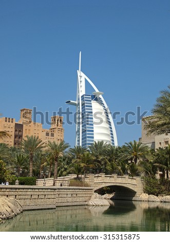 DUBAI/UNITED ARAB EMIRATES - MARCH 4, 2014: A view of the Burj al Arab Hotel and wind towers from a nearby shopping center.