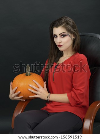 Young woman holding orange pumpkin close up,isolated