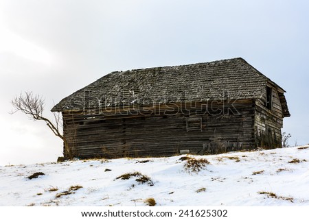 Old wooden barn in the countryside, in the winter