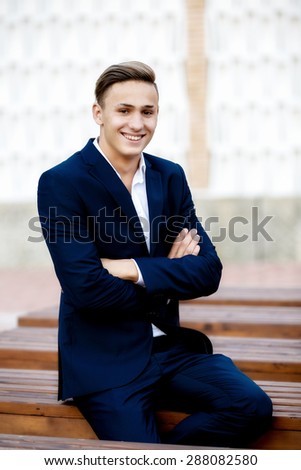 Young businessman relaxes in park