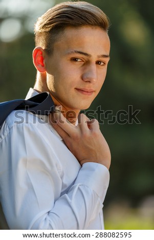 Young businessman relaxes in park