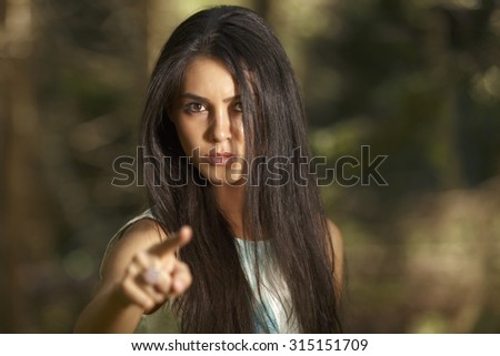 Closeup portrait of young angry woman pointing at someone as if to say you did something wrong,