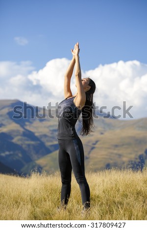 Exercising fitness woman doing exercises in nature.  Fit female Asian Caucasian athlete sport model