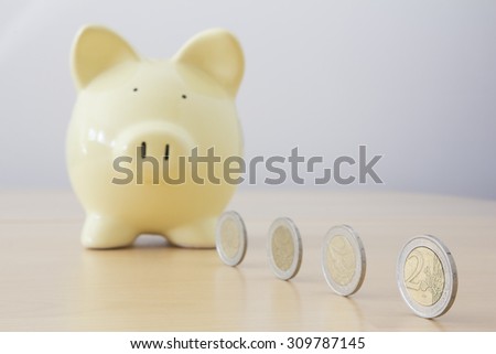 Yellow piggy bank and Euro currency, EUR