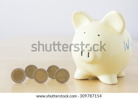 Yellow piggy bank and Euro currency, EUR