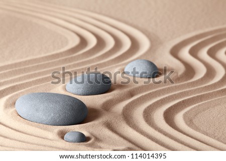 zen garden stones in row pattern in sand and rocks for relaxation and concentration during meditation