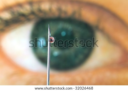 The eye of a doctor looking at a droplet on a syringe flu vaccination needle