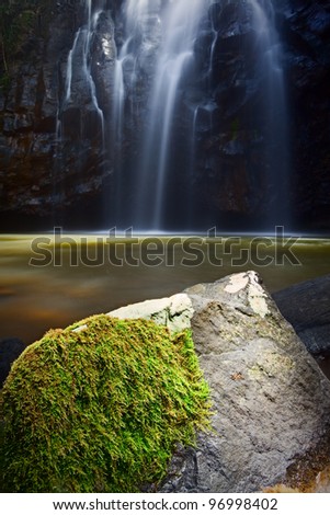 idyllic paradise waterfall with green moss growing on the rocks tranquil natural purity smooth blurred surface
