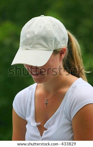 young lady in white baseball hat