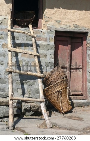 Wooden ladder and basket next to the door