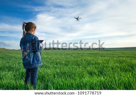 Similar – Image, Stock Photo Little kid operating drone in field