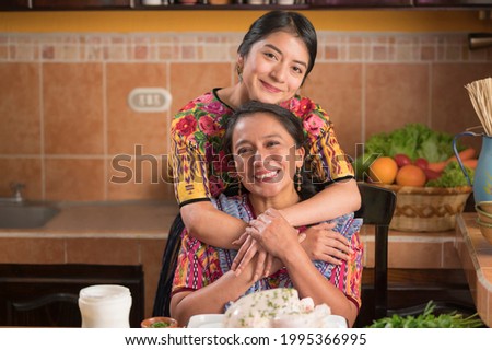 Mother's Day. Mother and daughter in the kitchen smiling at the camera. Stok fotoğraf © 