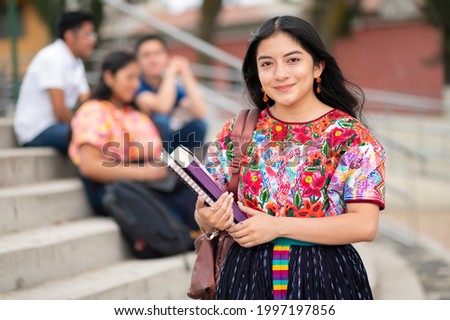 Portrait of an indigenous college student with books in hands in the university building. Back to school. Foto stock © 