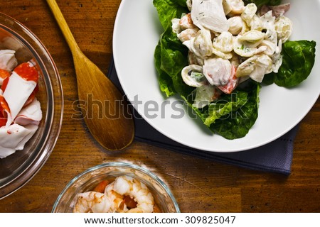 Summer seafood pasta salad with shrimp, crab meat and butter lettuce.