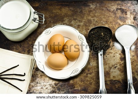 Rustic Food Ingredients / Ingredients to make homemade black tea ice cream â?? eggs, milk, loose-leaf black tea, sugar, and vanilla.