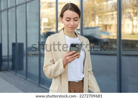 Similar – Image, Stock Photo Smiling businesswoman standing near gray wall