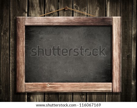 Grunge small blackboard hanging on wooden wall as a background for your message