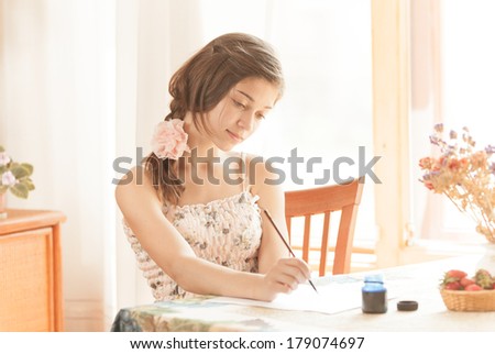 Girl writing at table by pen and ink at window. Retro stylized image.